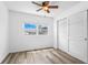Clean bedroom featuring a ceiling fan, closet and window with natural light at 8716 Hickorywood Ln, Tampa, FL 33615