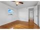 Bedroom featuring hardwood floors, a ceiling fan, and a window at 8716 Hickorywood Ln, Tampa, FL 33615