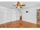 Bedroom with hardwood flooring, a ceiling fan, an en-suite bathroom, and a closet at 8716 Hickorywood Ln, Tampa, FL 33615