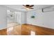 Bedroom featuring hardwood floors, a ceiling fan, a closet, and a window at 8716 Hickorywood Ln, Tampa, FL 33615