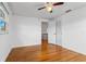 Bedroom featuring hardwood floors, a ceiling fan, a window, and a closet at 8716 Hickorywood Ln, Tampa, FL 33615