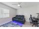 Bonus room featuring a leather electric recliner with cupholders, fan, a small desk and purple LED accent lights at 8716 Hickorywood Ln, Tampa, FL 33615