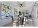 Open dining area with modern table and chairs, stylish art and views of the seating area with a TV at 8716 Hickorywood Ln, Tampa, FL 33615