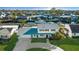 Stunning two-story waterfront home with lush landscaping and a charming front porch, ideal for enjoying serene views at 8716 Hickorywood Ln, Tampa, FL 33615
