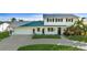 Inviting home exterior featuring a well-maintained lawn, attached garage, and classic architectural details at 8716 Hickorywood Ln, Tampa, FL 33615
