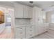 Bright kitchen with plenty of storage space, white cabinets, marble backsplash, and hardwood floors at 8716 Hickorywood Ln, Tampa, FL 33615