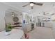 Open-concept kitchen with stainless steel appliances, white cabinetry, and an adjacent living area at 8716 Hickorywood Ln, Tampa, FL 33615