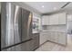 Modern kitchen features stainless steel appliances, white cabinets, and sleek countertops at 8716 Hickorywood Ln, Tampa, FL 33615