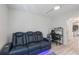 A comfortable living room equipped with a recliner sofa and adjacent office setup, ideal for relaxation and work at 8716 Hickorywood Ln, Tampa, FL 33615