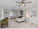 Living room features a ceiling fan, comfortable seating, and hardwood floors at 8716 Hickorywood Ln, Tampa, FL 33615