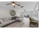 Living room features a ceiling fan, comfortable seating, and hardwood floors at 8716 Hickorywood Ln, Tampa, FL 33615