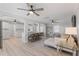 Living room features a ceiling fan, comfortable seating, and hardwood floors with an open floorplan at 8716 Hickorywood Ln, Tampa, FL 33615