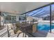 Outdoor patio area next to the pool with an outdoor television set at 8716 Hickorywood Ln, Tampa, FL 33615