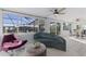 Bright sun room features stylish seating, white plank ceiling, and a view of the screened outdoor pool at 8716 Hickorywood Ln, Tampa, FL 33615