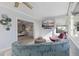 Comfortable sun room with a large TV, stylish seating, and views into another room with a white couch at 8716 Hickorywood Ln, Tampa, FL 33615