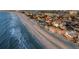Stunning aerial view of beachfront homes with ocean views and sandy shoreline at 8750 Harrell Ave, Treasure Island, FL 33706