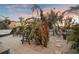 A private backyard patio with elegant seating surrounded by lush tropical plants at 8750 Harrell Ave, Treasure Island, FL 33706