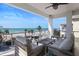 This balcony features comfortable seating and a table with great views over the beach and the ocean at 8750 Harrell Ave, Treasure Island, FL 33706