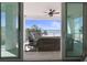 This balcony has a ceiling fan and seating overlooking the beach with sliding glass doors to the home's interior at 8750 Harrell Ave, Treasure Island, FL 33706