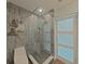 Modern bathroom with glass-enclosed shower, rain shower head, stylish tiles and contemporary decorative touches at 8750 Harrell Ave, Treasure Island, FL 33706