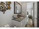 Well-appointed bathroom with a white vanity and decorative turtles on the wall, leading to the bedroom at 8750 Harrell Ave, Treasure Island, FL 33706