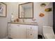 Bright bathroom showcases white cabinets, granite countertop, and nautical themed decor at 8750 Harrell Ave, Treasure Island, FL 33706