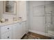 Modern bathroom with a vanity, granite countertop, and a glass-enclosed shower at 8750 Harrell Ave, Treasure Island, FL 33706