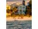 View of beach with beachgoers enjoying the sun in front of a multi-story building at 8750 Harrell Ave, Treasure Island, FL 33706