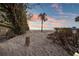 Sandy beach path leading to tranquil ocean with lush greenery and peaceful setting at 8750 Harrell Ave, Treasure Island, FL 33706