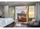 This bedroom features a beach view, ceiling fan, balcony access, hardwood floors, and warm lighting at 8750 Harrell Ave, Treasure Island, FL 33706