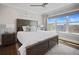 Cozy bedroom features a large window, neutral colors, and a comfortable bed with stylish bedding at 8750 Harrell Ave, Treasure Island, FL 33706