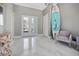 Bright and airy foyer with marble floors, modern art, and comfortable seating, creating an inviting ambiance at 8750 Harrell Ave, Treasure Island, FL 33706