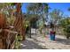 Charming front yard features lush plants, stepping stones, and a black metal fence at 8750 Harrell Ave, Treasure Island, FL 33706