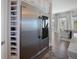 Chef's kitchen features a stainless steel refrigerator, wine storage, and a view into the living area at 8750 Harrell Ave, Treasure Island, FL 33706