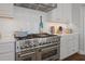 Professional-grade range in a stylish kitchen with custom cabinetry and countertops at 8750 Harrell Ave, Treasure Island, FL 33706