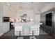Bright, open kitchen with a large marble island, stainless steel appliances, and custom white cabinetry at 8750 Harrell Ave, Treasure Island, FL 33706