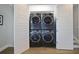 Compact laundry closet features a stacked washer and dryer set behind white double doors at 8750 Harrell Ave, Treasure Island, FL 33706