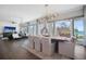 Spacious living room with dining area and sliding glass doors that look out to blue water at 8750 Harrell Ave, Treasure Island, FL 33706