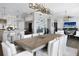 Spacious living room with dining area and kitchen featuring modern decor, hardwood floors, and neutral tones at 8750 Harrell Ave, Treasure Island, FL 33706