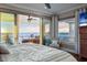 Bright main bedroom offering stunning views of the ocean through sliding glass doors and beautiful sunset at 8750 Harrell Ave, Treasure Island, FL 33706
