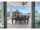 Outdoor patio with a dining table overlooking the ocean and beach views; a relaxing entertaining space at 8750 Harrell Ave, Treasure Island, FL 33706