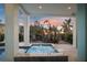 Secluded outdoor patio features bubbling hot tub, lounging and seating amidst tropical plants at 8750 Harrell Ave, Treasure Island, FL 33706