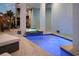 Relaxing pool and spa with a blue mosaic tile accent for a refreshing oasis at 8750 Harrell Ave, Treasure Island, FL 33706
