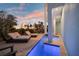 A captivating outdoor space featuring a pool, spa, and comfortable lounge chairs under a twilight sky at 8750 Harrell Ave, Treasure Island, FL 33706