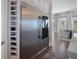 Stainless steel refrigerator with wine racks adjacent to light-filled dining area at 8750 Harrell Ave, Treasure Island, FL 33706