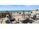 Inviting rooftop deck featuring a lounge area with beach and ocean views in the background at 8750 Harrell Ave, Treasure Island, FL 33706