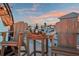 Lovely rooftop deck showcasing Adirondack chairs, table, wine and glasses with a beautiful twilight sky at 8750 Harrell Ave, Treasure Island, FL 33706