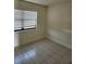 Cozy bedroom with tile floors and a large window at 12500 Capri Cir N # 302, Treasure Island, FL 33706