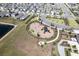 Aerial view of a modern community featuring a playground and lush landscaping at 16719 Delia St, Wimauma, FL 33598