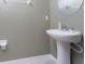 Clean pedestal sink with neutral paint and modern fixtures in a half-bathroom at 16719 Delia St, Wimauma, FL 33598